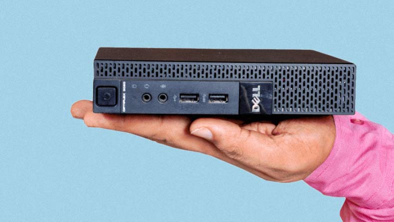 man holding a dell optiplex 9020 tiny in one hand