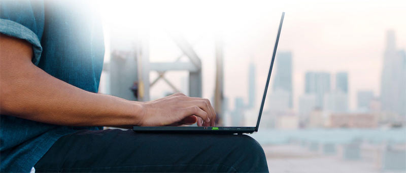 man woirkin with razer blade 15 on his lap